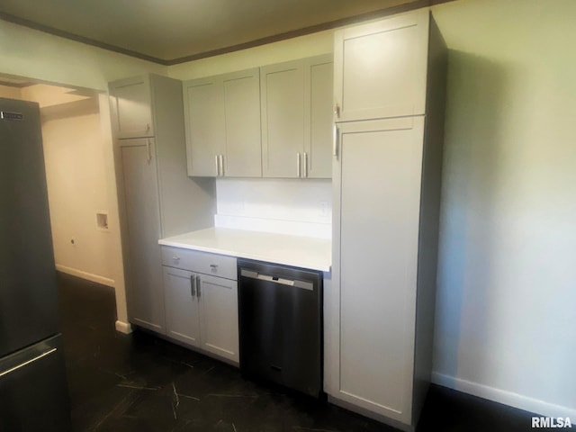 kitchen featuring light countertops, appliances with stainless steel finishes, and baseboards