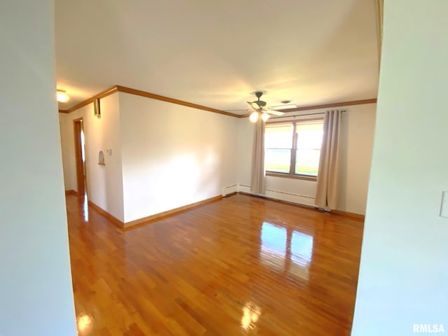 spare room featuring ornamental molding, a ceiling fan, and wood finished floors