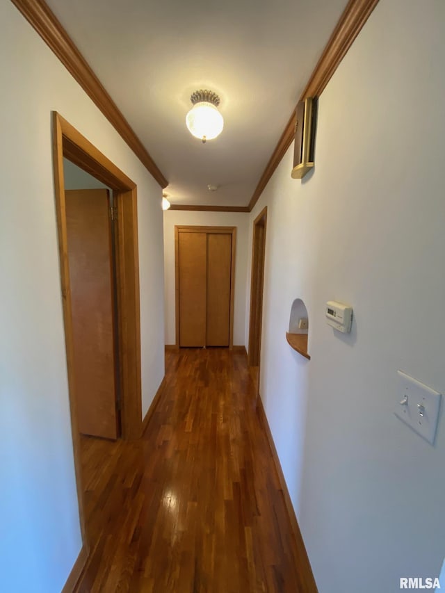 hall featuring wood finished floors and ornamental molding