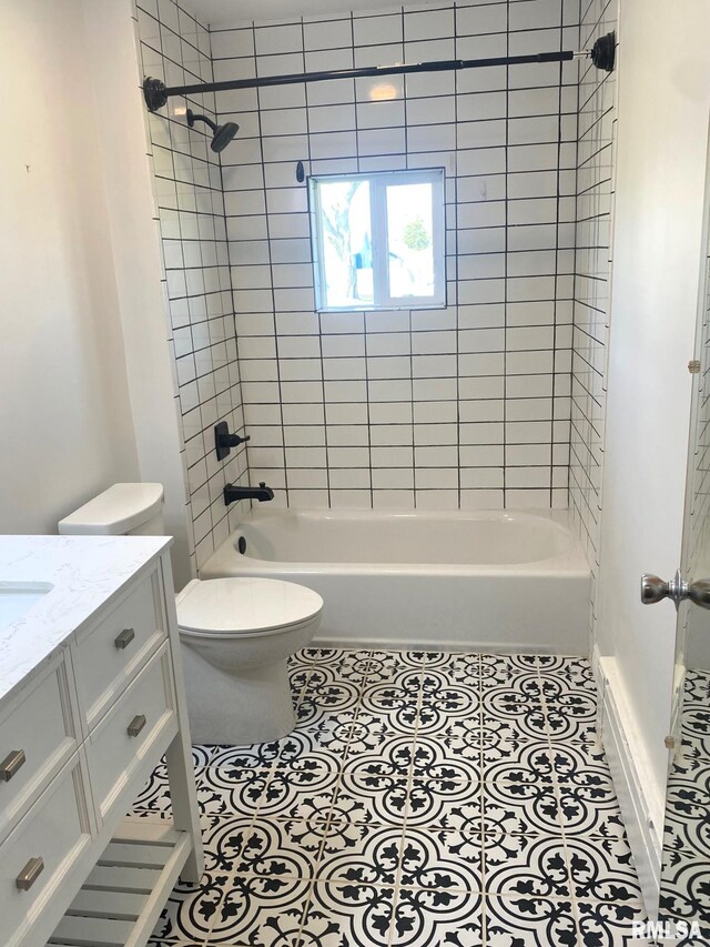 bathroom with toilet, vanity, and washtub / shower combination
