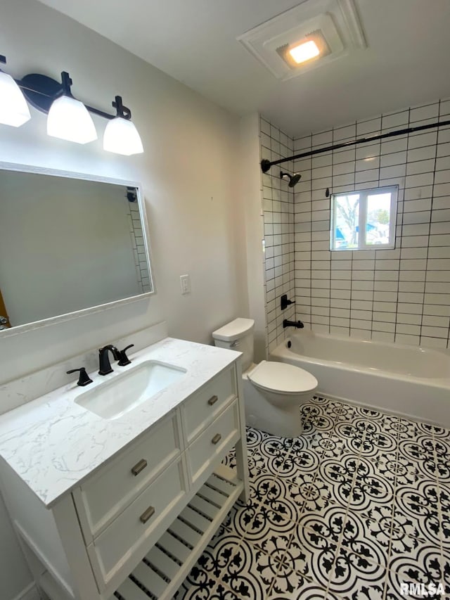 full bath featuring toilet, tile patterned floors, vanity, and shower / washtub combination