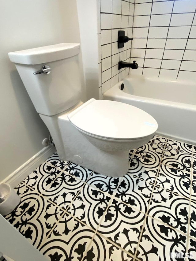 bathroom with toilet, tile patterned floors, and  shower combination