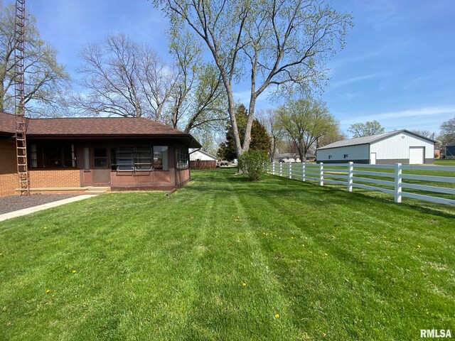 view of yard with a garage and fence