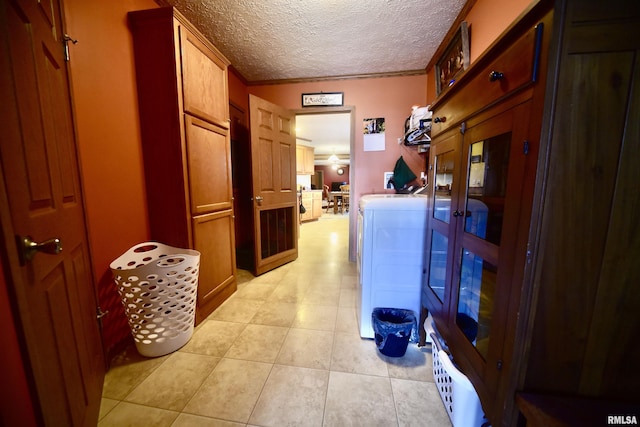 24 Davis Rd, Cave In Rock, IL 62919 - hallway with light tile patterned floors, a textured ceiling, ornamental molding, french doors, and washer and clothes dryer