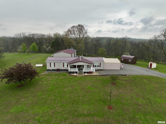 24 Davis Rd, Cave In Rock, IL 62919 - view of front of home featuring a front yard, metal roof, driveway, and a forest view