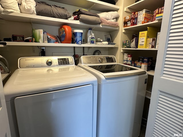 laundry room featuring separate washer and dryer and laundry area