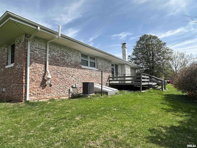 view of home's exterior with a wooden deck, central AC unit, and a lawn