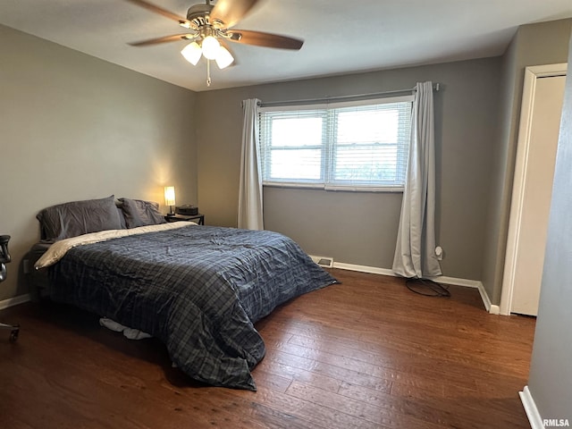 bedroom with baseboards, ceiling fan, and hardwood / wood-style floors