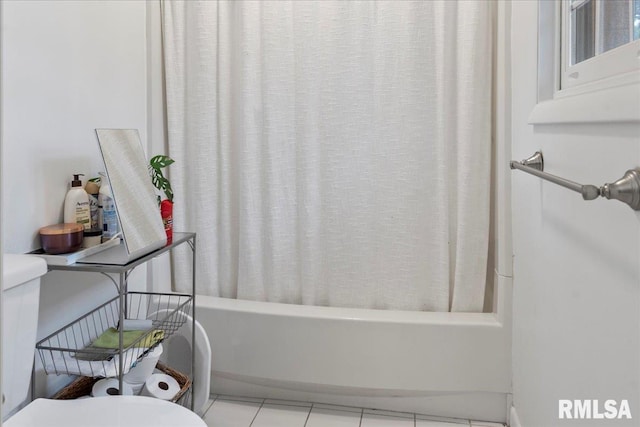 bathroom featuring toilet, tile patterned floors, and shower / bathtub combination with curtain