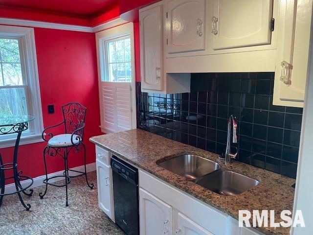kitchen featuring a sink, white cabinetry, and dishwasher