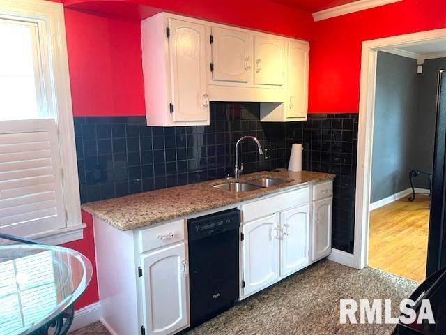 kitchen featuring dishwasher, white cabinetry, and a sink