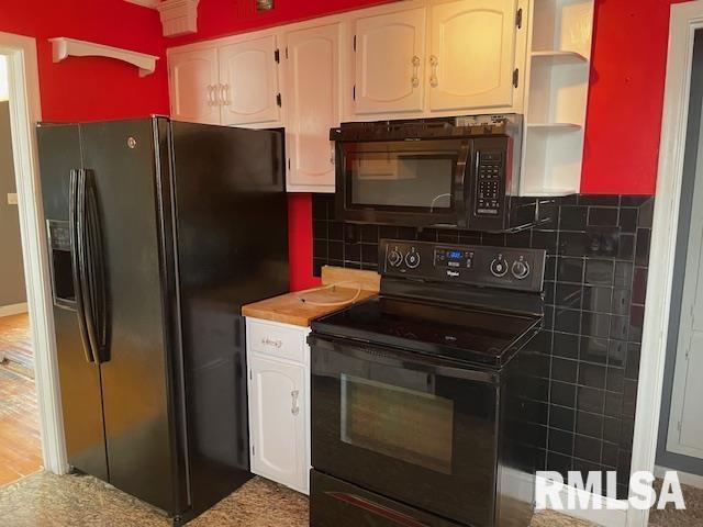 kitchen with light countertops, open shelves, white cabinets, decorative backsplash, and black appliances