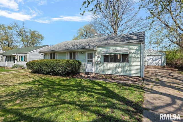 view of front of home with a garage, a front yard, driveway, and an outdoor structure