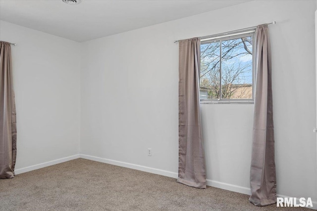 carpeted empty room with baseboards