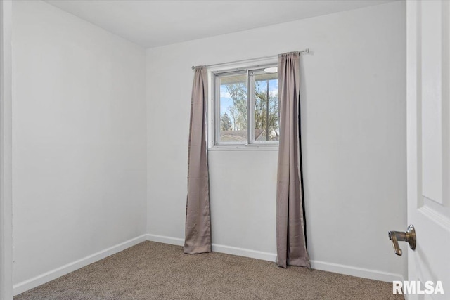 empty room with carpet flooring and baseboards