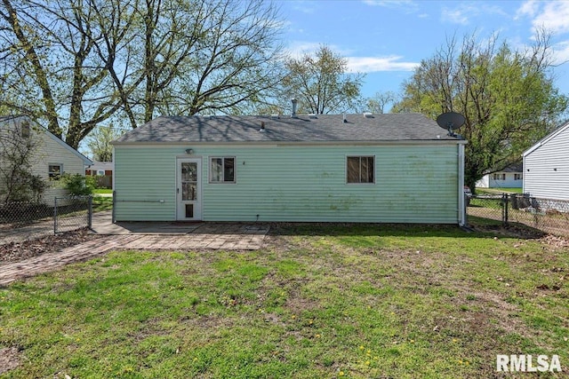 back of house featuring a patio area, a fenced backyard, and a lawn