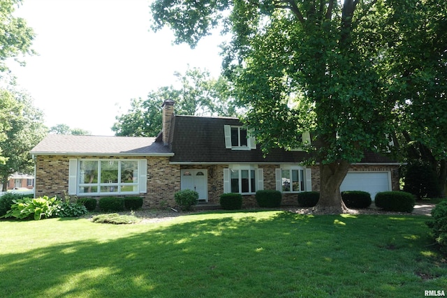 50 Hackberry Cir, Galesburg, IL 61401 - view of front of house with a front lawn, brick siding, a chimney, and a garage
