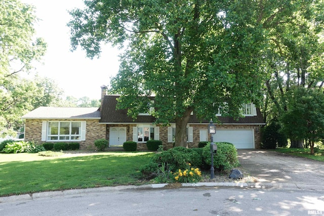50 Hackberry Cir, Galesburg, IL 61401 - view of front facade with an attached garage, driveway, a front lawn, brick siding, and a chimney