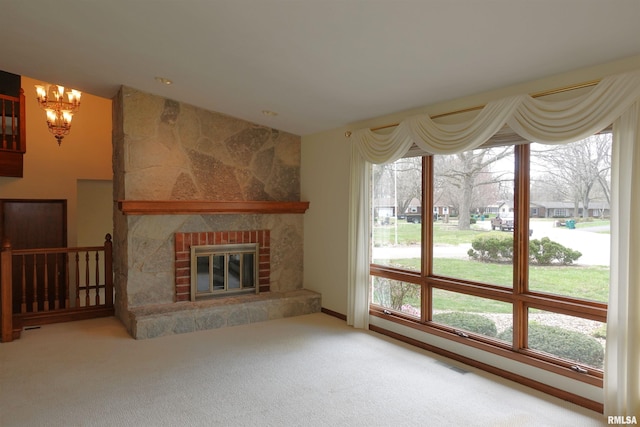 50 Hackberry Cir, Galesburg, IL 61401 - unfurnished living room with a chandelier, carpet flooring, and a fireplace