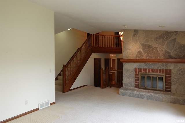 50 Hackberry Cir, Galesburg, IL 61401 - unfurnished living room with carpet floors, stairway, a chandelier, and a glass covered fireplace