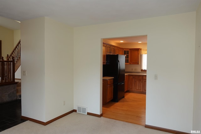 50 Hackberry Cir, Galesburg, IL 61401 - kitchen with freestanding refrigerator, light carpet, brown cabinets, light countertops, and glass insert cabinets
