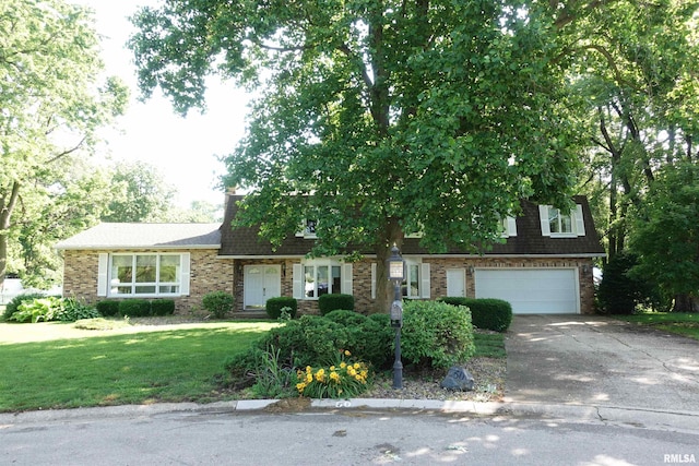 50 Hackberry Cir, Galesburg, IL 61401 - view of front of house with an attached garage, driveway, a front yard, and brick siding