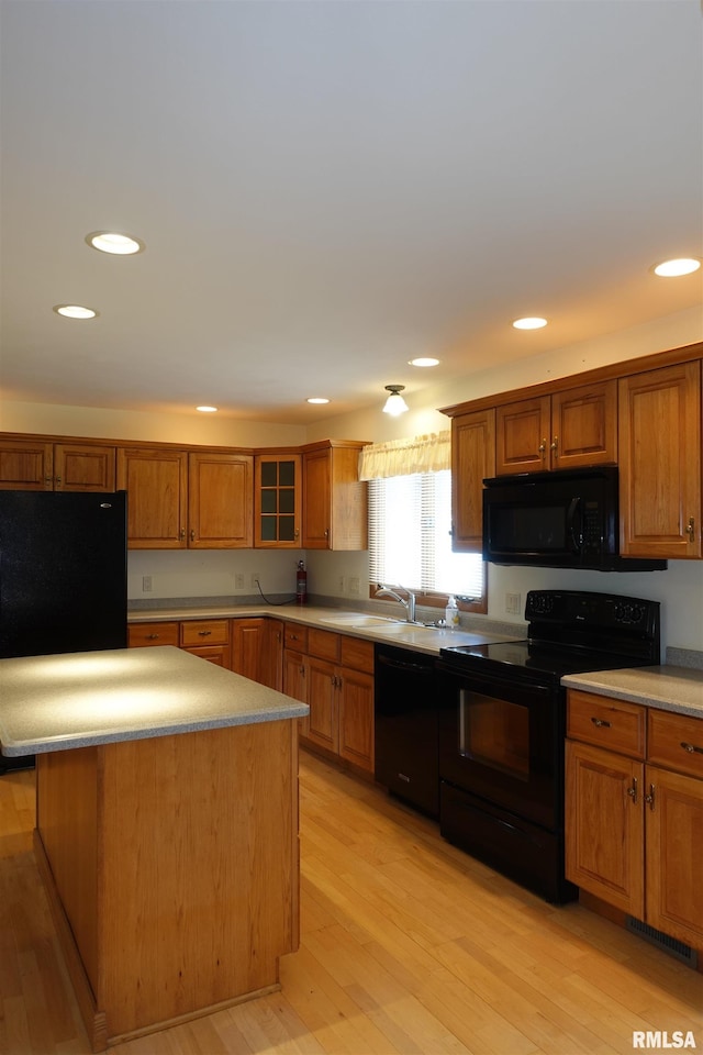 50 Hackberry Cir, Galesburg, IL 61401 - kitchen featuring black appliances, light wood-style floors, brown cabinetry, recessed lighting, and light countertops