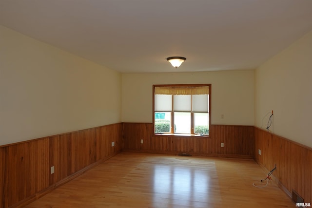 50 Hackberry Cir, Galesburg, IL 61401 - empty room with a wainscoted wall, light wood-style flooring, and wooden walls