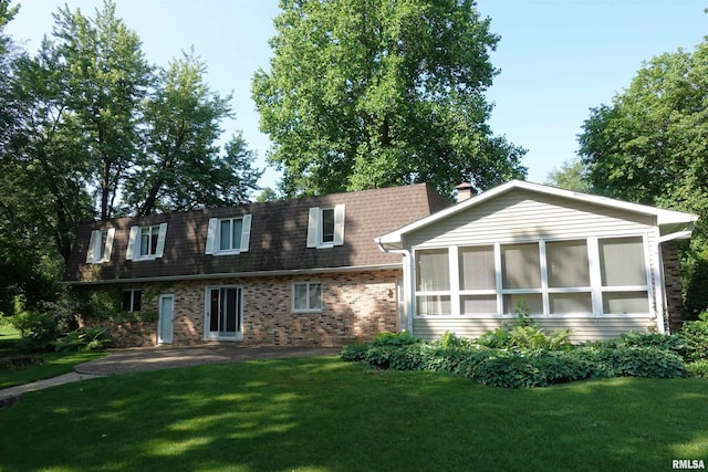 50 Hackberry Cir, Galesburg, IL 61401 - rear view of house featuring brick siding, a yard, a sunroom, and roof with shingles