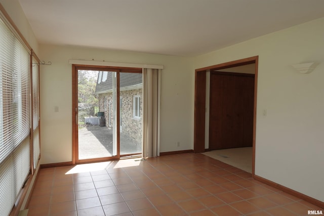 50 Hackberry Cir, Galesburg, IL 61401 - tiled empty room featuring baseboards