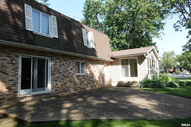 50 Hackberry Cir, Galesburg, IL 61401 - rear view of property featuring brick siding, entry steps, and roof with shingles