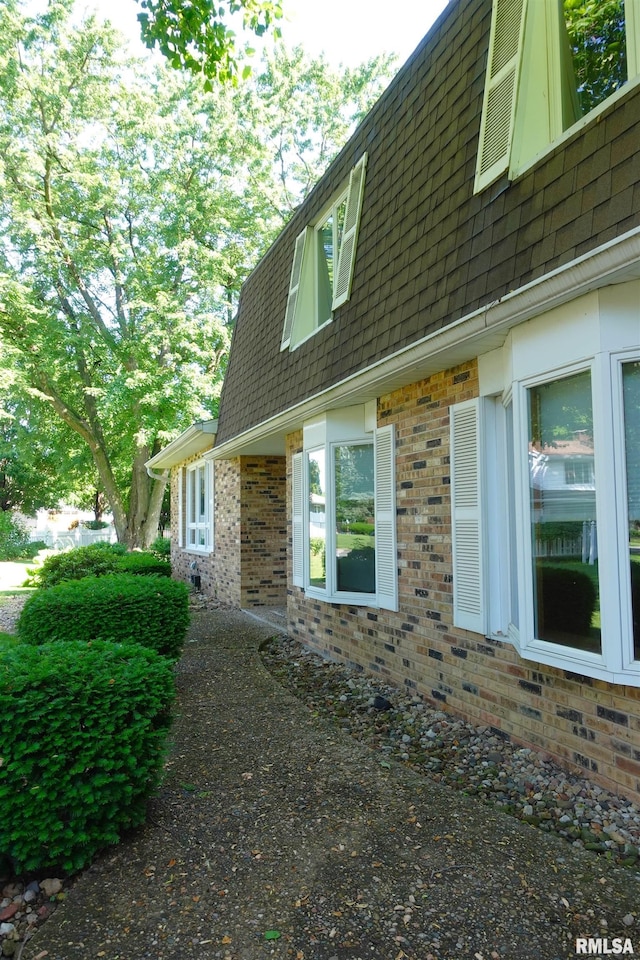 50 Hackberry Cir, Galesburg, IL 61401 - view of side of property featuring brick siding, roof with shingles, and mansard roof