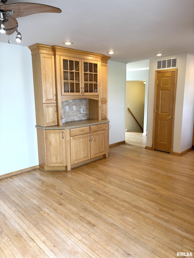 2110 Magnolia Dr, Jacksonville, IL 62650 - kitchen with recessed lighting, glass insert cabinets, visible vents, light wood finished floors, and light brown cabinetry