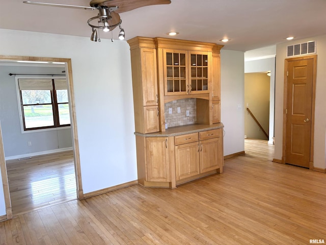 2110 Magnolia Dr, Jacksonville, IL 62650 - kitchen with light wood-style floors, baseboards, a ceiling fan, and visible vents