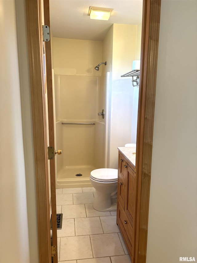 2110 Magnolia Dr, Jacksonville, IL 62650 - bathroom featuring toilet, a stall shower, vanity, and tile patterned flooring