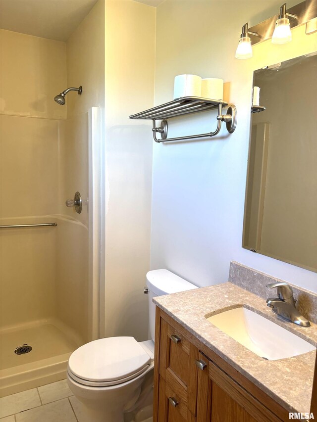 2110 Magnolia Dr, Jacksonville, IL 62650 - full bathroom with toilet, a stall shower, vanity, and tile patterned flooring