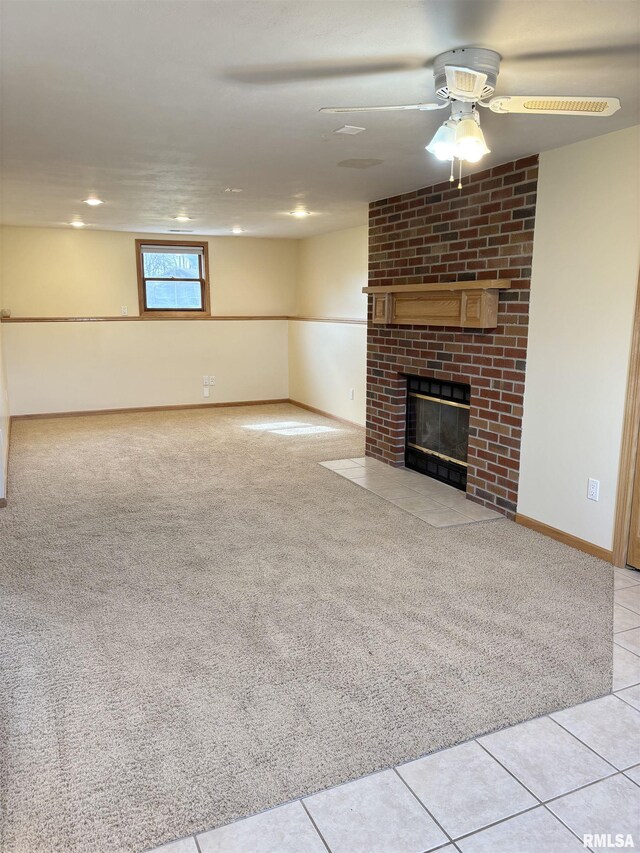 2110 Magnolia Dr, Jacksonville, IL 62650 - unfurnished living room featuring light tile patterned floors, a brick fireplace, light colored carpet, and a ceiling fan