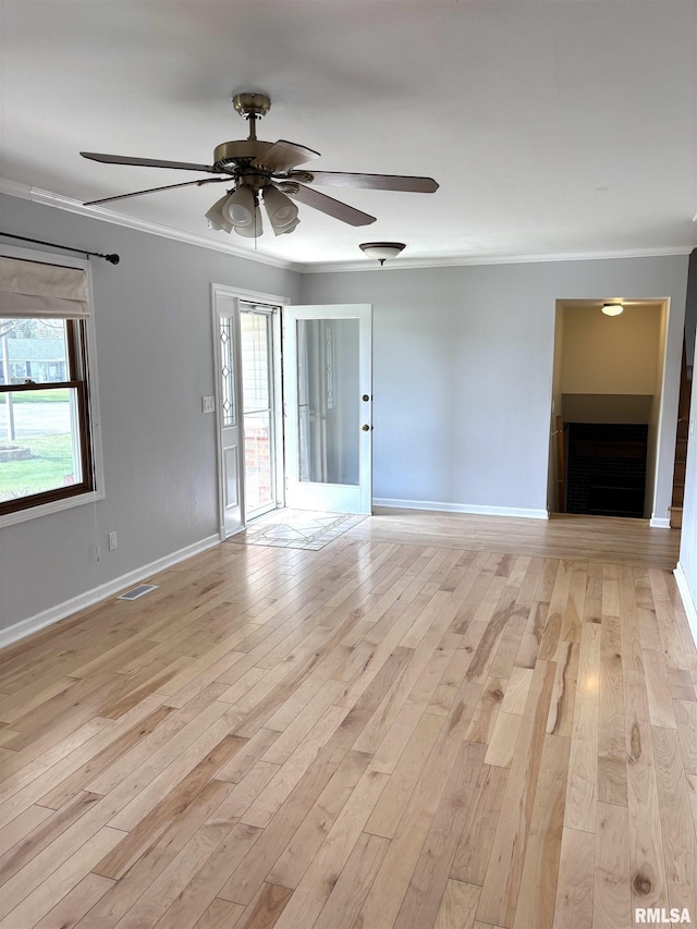 2110 Magnolia Dr, Jacksonville, IL 62650 - spare room featuring light wood finished floors, visible vents, ornamental molding, and a ceiling fan