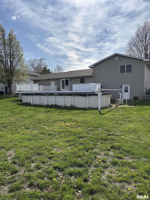 2110 Magnolia Dr, Jacksonville, IL 62650 - rear view of house featuring a covered pool and a lawn