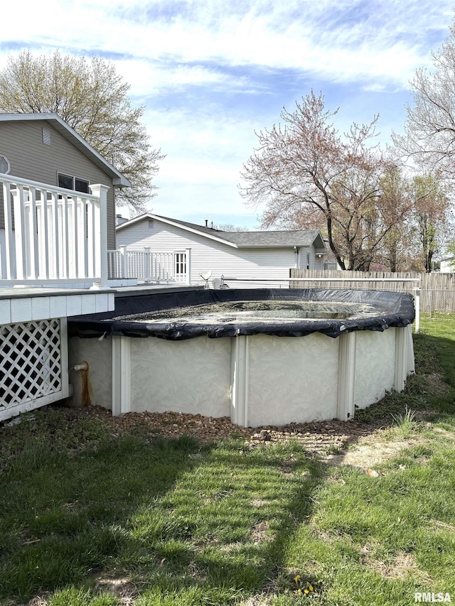 2110 Magnolia Dr, Jacksonville, IL 62650 - exterior space with a deck, a yard, fence, stucco siding, and a fenced in pool