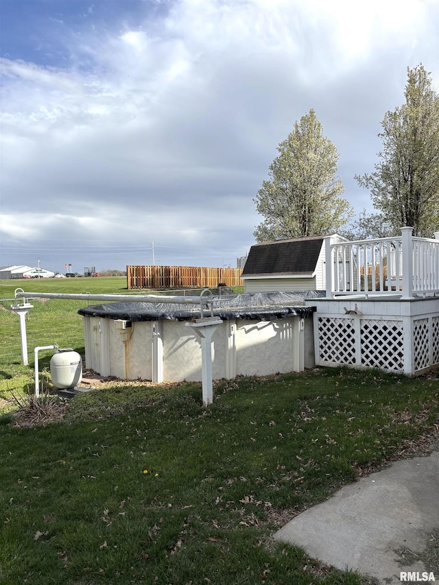 2110 Magnolia Dr, Jacksonville, IL 62650 - view of swimming pool with a covered pool, a wooden deck, and a lawn