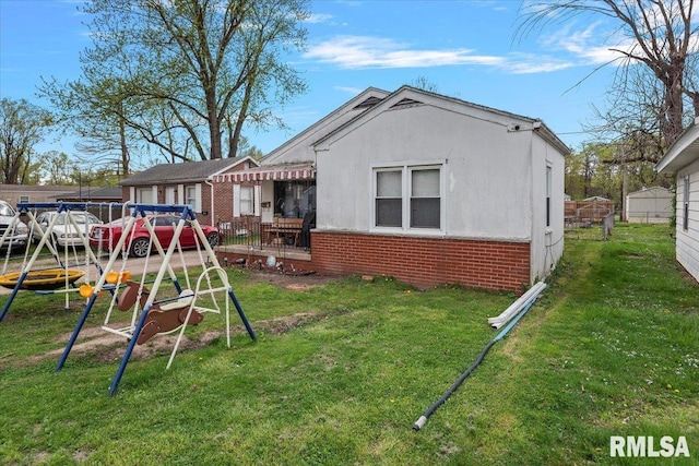 417 N Stephens Ave, Springfield, IL 62702 - back of house featuring brick siding and a yard