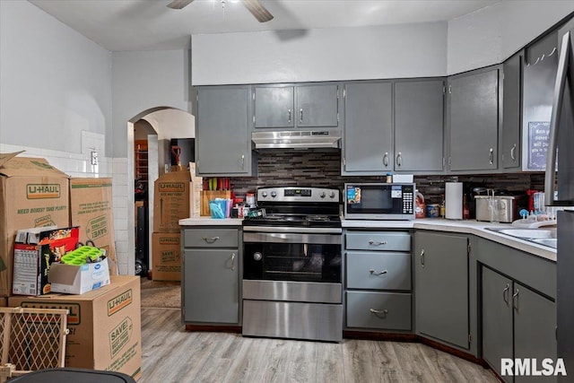 417 N Stephens Ave, Springfield, IL 62702 - kitchen with stainless steel appliances, gray cabinetry, under cabinet range hood, and arched walkways