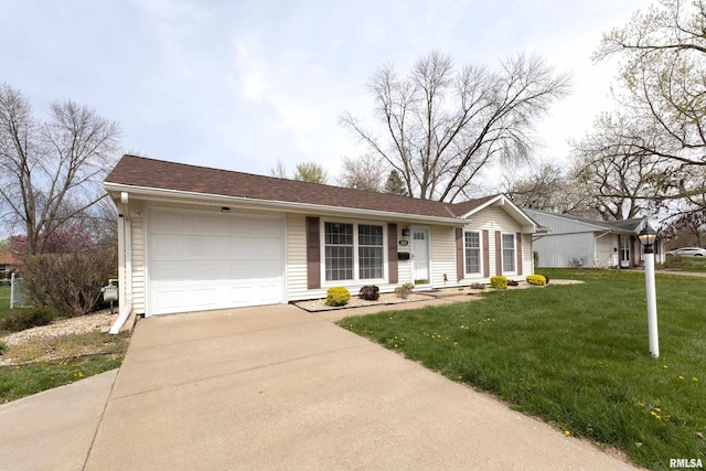single story home with a garage, a front yard, and concrete driveway