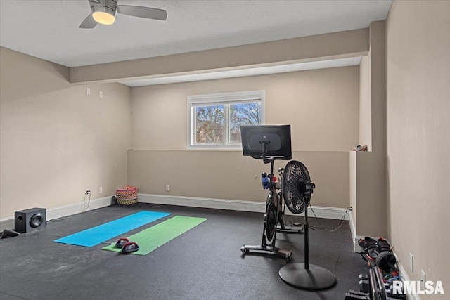 workout room featuring baseboards and a ceiling fan