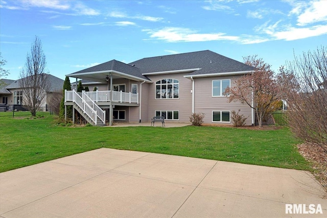 rear view of house with a patio area, fence, a lawn, and stairs
