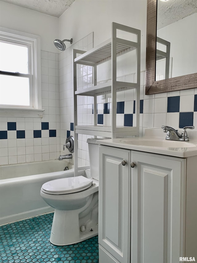 bathroom featuring a textured ceiling, vanity, washtub / shower combination, backsplash, and toilet