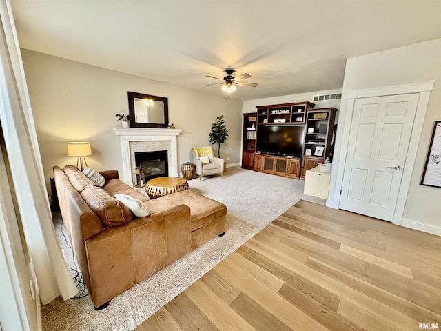 3096 Whitehaven Cir, Galesburg, IL 61401 - living room featuring light wood-style flooring, visible vents, a fireplace, and ceiling fan