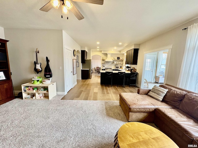 3096 Whitehaven Cir, Galesburg, IL 61401 - living room featuring light wood-type flooring, ceiling fan, arched walkways, baseboards, and recessed lighting