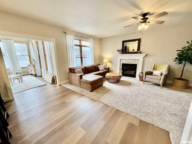 3096 Whitehaven Cir, Galesburg, IL 61401 - living area featuring baseboards, wood finished floors, a fireplace, and ceiling fan